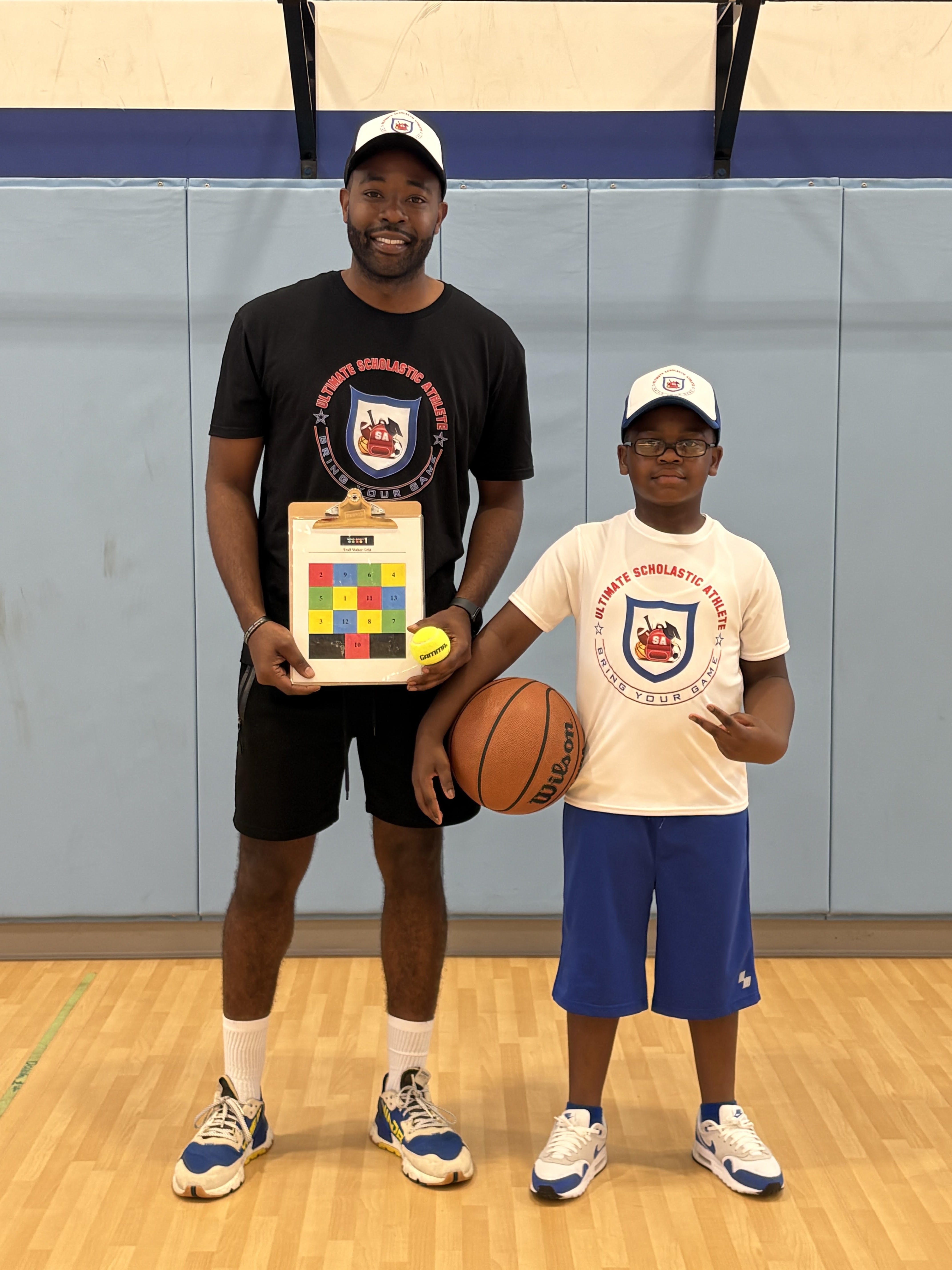 Josh Woodley with athlete holding basketball